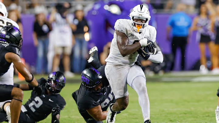 Sep 14, 2024; Fort Worth, Texas, USA; TCU Horned Frogs defensive lineman Caleb Fox (90) attempts a tackle on UCF Knights tight end Randy Pittman Jr. (5) during the fourth quarter at Amon G. Carter Stadium. Mandatory Credit: Andrew Dieb-Imagn Images