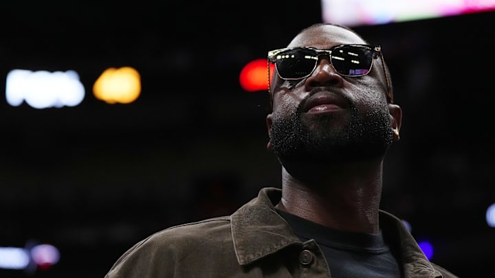 Jan 19, 2024; Miami, Florida, USA; Former Miami Heat player Dwayne Wade walks court-side during the second half of the game between the Miami Heat and the Atlanta Hawks at Kaseya Center. Mandatory Credit: Jasen Vinlove-Imagn Images