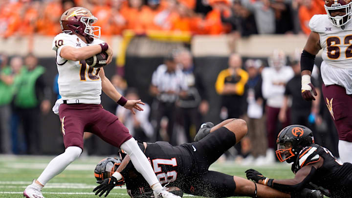 Arizona State Sun Devils quarterback Sam Leavitt (10) gets by the tackles of Oklahoma State Cowboys defensive end DeSean Brown (87) and Cam Smith (3)in the first half the college football game between the Oklahoma State Cowboys and the Arizona State Sun Devils at Boone Pickens Stadium in Stillwater, Okla., Saturday, Nov., 2, 2024.