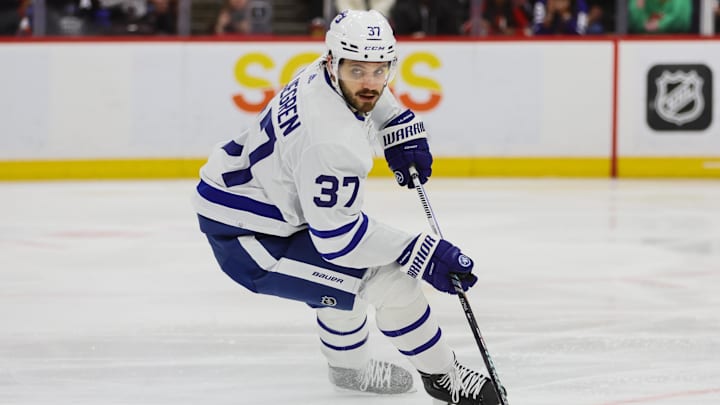 Apr 16, 2024; Sunrise, Florida, USA; Toronto Maple Leafs defenseman Timothy Liljegren (37) moves the puck against the Florida Panthers during the second period at Amerant Bank Arena. Mandatory Credit: Sam Navarro-Imagn Images