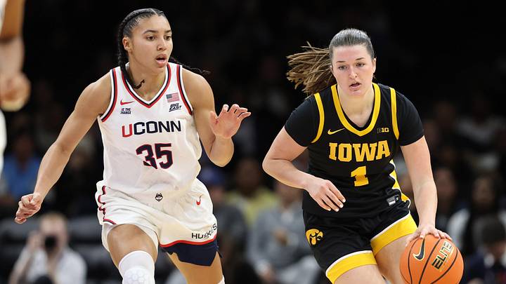 Dec 20, 2025; Brooklyn, New York, USA; Iowa Hawkeyes guard Taylor Stremlow (1) dribbles the ball against UConn Huskies guard Azzi Fudd (35) during the first half at Barclays Center. Mandatory Credit: Pamela Smith-Imagn Images