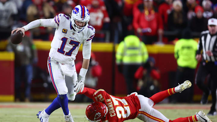 Buffalo Bills quarterback Josh Allen rushes the ball past Kansas City Chiefs safety Chamarri Conner.