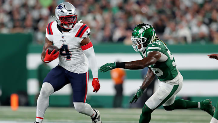 Sep 19, 2024; East Rutherford, New Jersey, USA; New England Patriots running back Antonio Gibson (4) runs with the ball against New York Jets linebacker Quincy Williams (56) during the second quarter at MetLife Stadium. Mandatory Credit: Brad Penner-Imagn Images