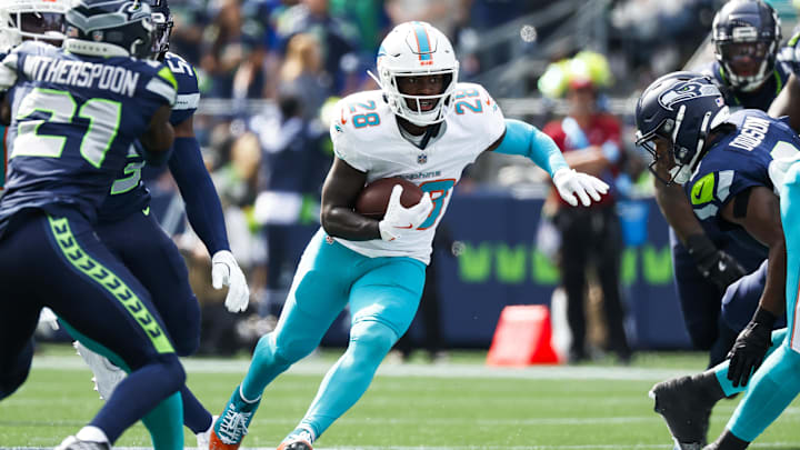 Miami Dolphins running back DeVon Achane (28) rushes against the Seattle Seahawks during the first quarter at Lumen Field.