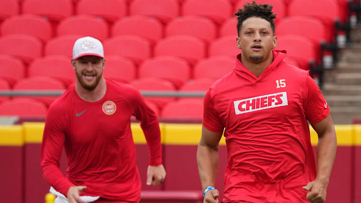 Aug 22, 2024; Kansas City, Missouri, USA; Kansas City Chiefs quarterback Patrick Mahomes (15) and quarterback Carson Wentz (11) warm up against the Chicago Bears prior to a game at GEHA Field at Arrowhead Stadium. Mandatory Credit: Denny Medley-Imagn Images