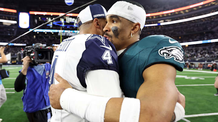 Dallas Cowboys quarterback Dak Prescott hugs Philadelphia Eagles quarterback Jalen Hurts.