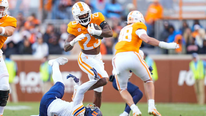 November 23, 2024. Tennessee running back Cameron Seldon (23) jumps over UTEP safety Oscar Moore (11).