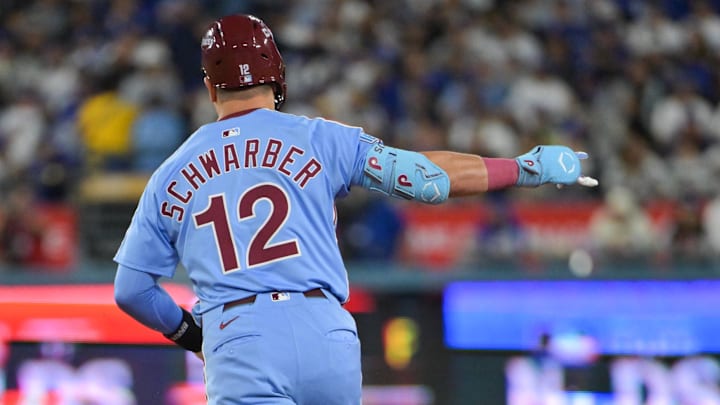 Oct 8, 2025; Los Angeles, California, USA; Philadelphia Phillies designated hitter Kyle Schwarber (12) celebrates after hitting a two run home run during the eighth inning against the Los Angeles Dodgers during game three of the NLDS round for the 2025 MLB playoffs at Dodger Stadium. Mandatory Credit: Jayne Kamin-Oncea-Imagn Images