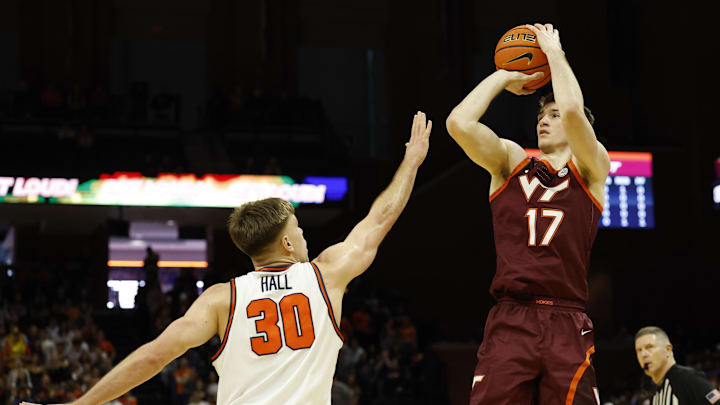 Mar 7, 2026; Charlottesville, Virginia, USA; Virginia Tech Hokies guard Neoklis Avdalas (17) shoots the ball as Virginia Cavaliers guard Dallin Hall (30) defends in the first half at John Paul Jones Arena. Mandatory Credit: Geoff Burke-Imagn Images