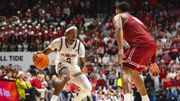 Feb 15, 2025; Tuscaloosa, Alabama, USA; Auburn Tigers guard Denver Jones (2) dribbles the ball against Alabama Crimson Tide guard Chris Youngblood (8) during the first half at Coleman Coliseum. Mandatory Credit: Will McLelland-Imagn Images