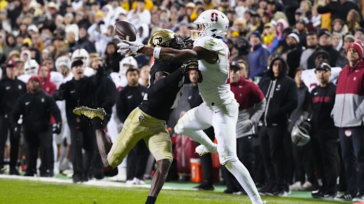 Oct 13, 2023; Boulder, Colorado, USA; Stanford Cardinal wide receiver Elic Ayomanor (13) pulls in a touchdown behind the pack of Colorado Buffaloes cornerback Travis Hunter (12) in overtime at Folsom Field. Mandatory Credit: Ron Chenoy-Imagn Images