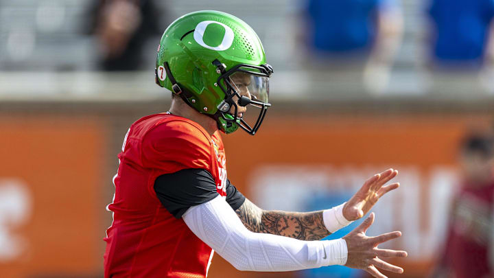Jan 28, 2025; Mobile, AL, USA; National team quarterback Dillon Gabriel of Oregon (8) runs a play during Senior Bowl practice for the National team at Hancock Whitney Stadium. Mandatory Credit: Vasha Hunt-Imagn Images