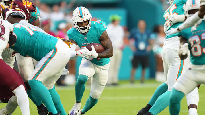 Aug 17, 2024; Miami Gardens, Florida, USA; Miami Dolphins running back Raheem Mostert (31) runs for a first down against the Washington Commanders during the first quarter at Hard Rock Stadium. Aug 17, 2024; Miami Gardens, Florida, USA; Miami Dolphins running back Raheem Mostert (31) runs for a first down against the Washington Commanders during the first quarter at Hard Rock Stadium.
