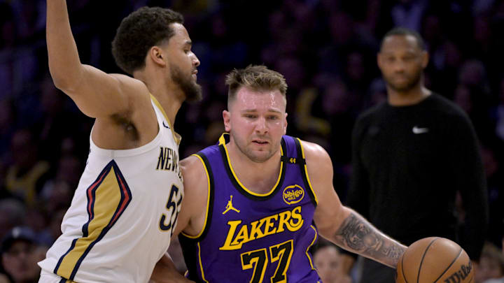 Apr 4, 2025; Los Angeles, California, USA; Los Angeles Lakers guard Luka Doncic (77) is defended by New Orleans Pelicans forward Jeremiah Robinson-Earl (50) in the first half at Crypto.com Arena. Mandatory Credit: Jayne Kamin-Oncea-Imagn Images Apr 4, 2025; Los Angeles, California, USA; Los Angeles Lakers guard Luka Doncic (77) is defended by New Orleans Pelicans forward Jeremiah Robinson-Earl (50) in the first half at Crypto.com Arena. Mandatory Credit: Jayne Kamin-Oncea-Imagn Images
