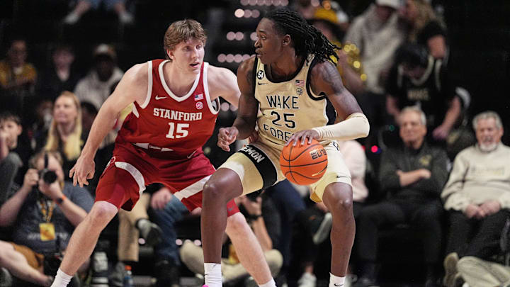 Feb 14, 2026; Winston-Salem, North Carolina, USA;  Wake Forest Demon Deacons forward Tre'von Spillers (25) handles the ball defended by Stanford Cardinal forward Oskar Giltay (15) during the second half at Lawrence Joel Veterans Memorial Coliseum. Mandatory Credit: Jim Dedmon-Imagn Images