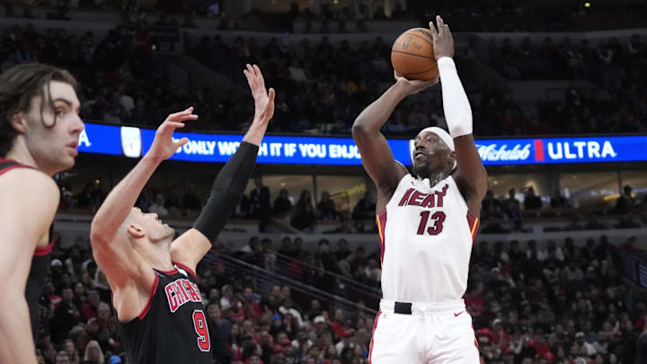 Apr 16, 2025; Chicago, Illinois, USA; Chicago Bulls center Nikola Vucevic (9) defends Miami Heat center Bam Adebayo (13) during the second half at United Center. Mandatory Credit: David Banks-Imagn Images