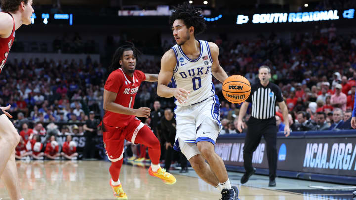 Mar 31, 2024; Dallas, TX, USA; Duke Blue Devils guard Jared McCain (0) controls the ball against North Carolina State Wolfpack guard Jayden Taylor (1) in the second half in the finals of the South Regional of the 2024 NCAA Tournament at American Airline Center. Mandatory Credit: Tim Heitman-USA TODAY Sports