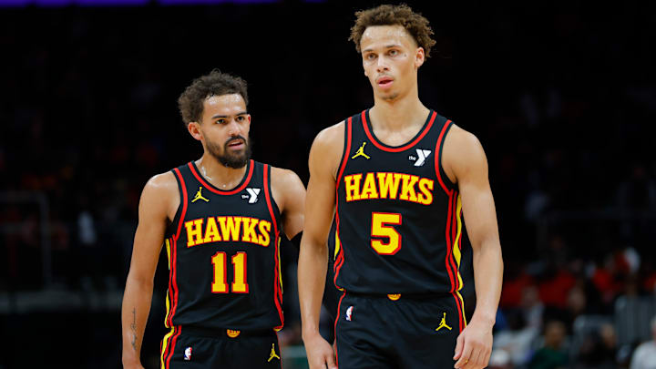 Trae Young #11 and Dyson Daniels #5 of the Atlanta Hawks look on against the Denver Nuggets.
