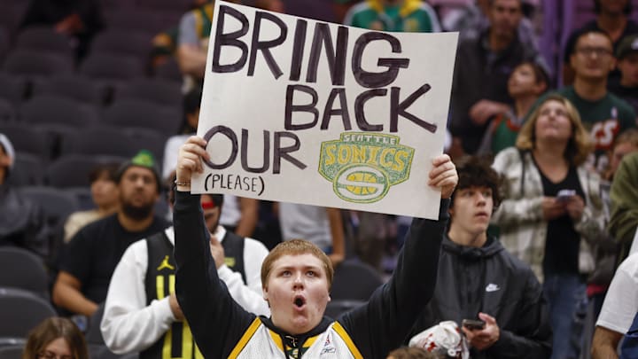 A Seattle Supersonics fan holds a sign advocating for their return during pregame warmups between the LA Clippers and Utah Jazz at Climate Pledge Arena.