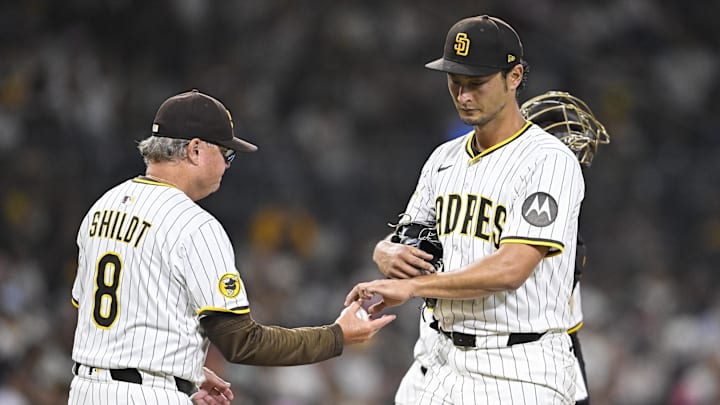 Sep 2, 2025; San Diego, California, USA; San Diego Padres starting pitcher Yu Darvish (11) hands the ball to manager Mike Shildt (8) as he leaves the game during the fifth inning against the Baltimore Orioles at Petco Park. Mandatory Credit: Denis Poroy-Imagn Images
