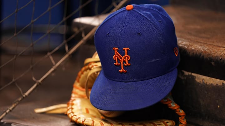 Aug 5, 2021; Miami, Florida, USA; A detailed view of the cap and mitt of New York Mets first baseman Pete Alonso (not pictured) on the dugout steps prior the the game against the Miami Marlins at loanDepot park. Mandatory Credit: Jasen Vinlove-Imagn Images