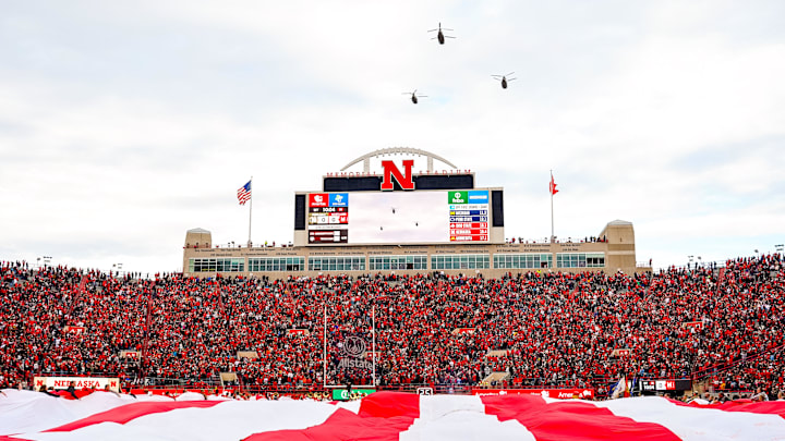 Nov 11, 2023; Lincoln, Nebraska, USA; Three CH-47 Chinook helicopters fly over the field during the