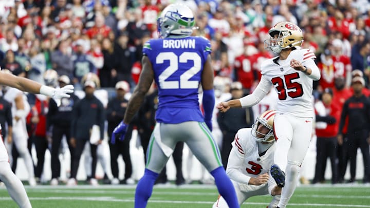 Oct 10, 2024; Seattle, Washington, USA; San Francisco 49ers place kicker Matthew Wright (35) kicks a field goal against the Seattle Seahawks during the first quarter at Lumen Field. San Francisco 49ers holder Mitch Wishnowsky (3) watches the kick.