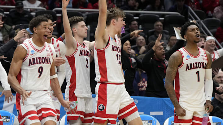 Arizona Wildcats forward Carter Bryant (9), guard Anthony Dell'Orso (3), forward Henri Veesaar (13) and guard Caleb Love (1) react on the bench against the Akron Zips during the second half in the first round of the NCAA Tournament at Climate Pledge Arena.