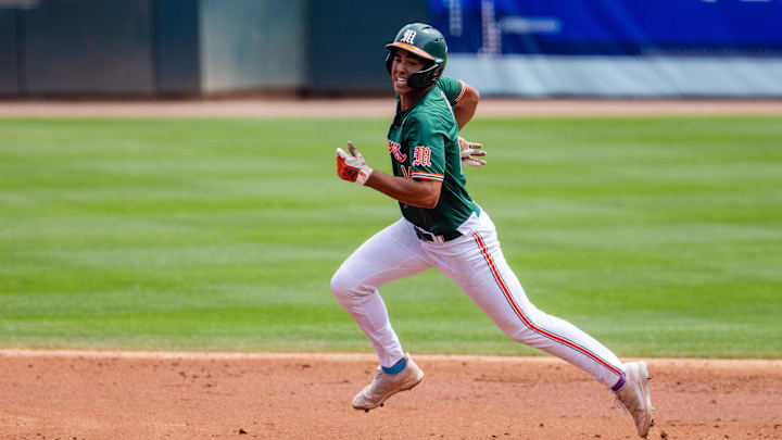 May 23, 2024; Charlotte, NC, USA; Miami (Fl) Hurricanes infielder Daniel Cuvet (14) heads to third against the Clemson Tigers in the second inning during the ACC Baseball Tournament at Truist Field. Mandatory Credit: Scott Kinser-Imagn Images