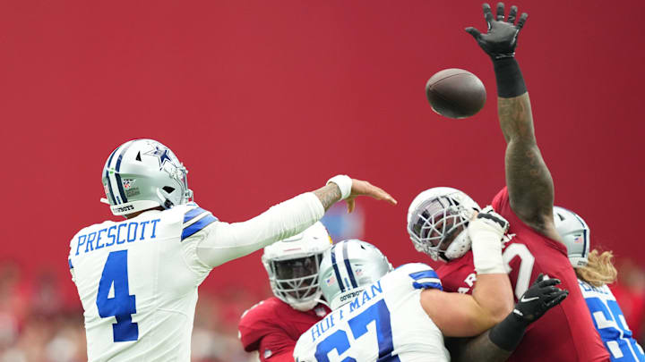 Dallas Cowboys quarterback Dak Prescott throws over the reach of Arizona Cardinals defensive end Kevin Strong. Dallas Cowboys quarterback Dak Prescott throws over the reach of Arizona Cardinals defensive end Kevin Strong.