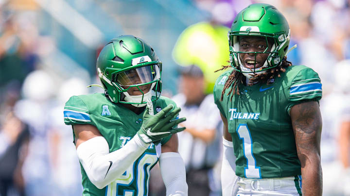 Aug 30, 2025; New Orleans, Louisiana, USA;  Tulane Green Wave defensive back Jahiem Johnson (20) and Tulane Green Wave safety Jack Tchienchou (1) react to a play against Northwestern Wildcats during the second half at Yulman Stadium. Mandatory Credit: Stephen Lew-Imagn Images