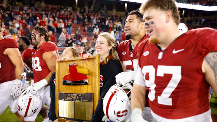 Nov 22, 2025; Stanford, California, USA; Stanford Cardinal players take possession of the axe after the game against the California Golden Bears at Stanford Stadium. Mandatory Credit: Sergio Estrada-Imagn Images
