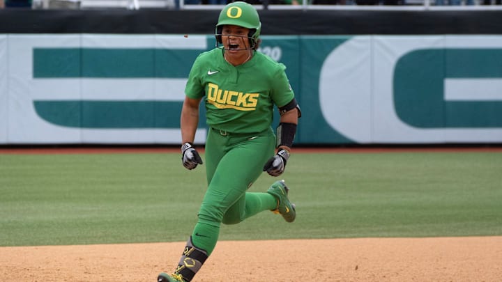 Oregon’s Dezianna Patmon celebrates on her way to home during the fourth inning against Weber State in the Eugene NCAA Softball Regional.