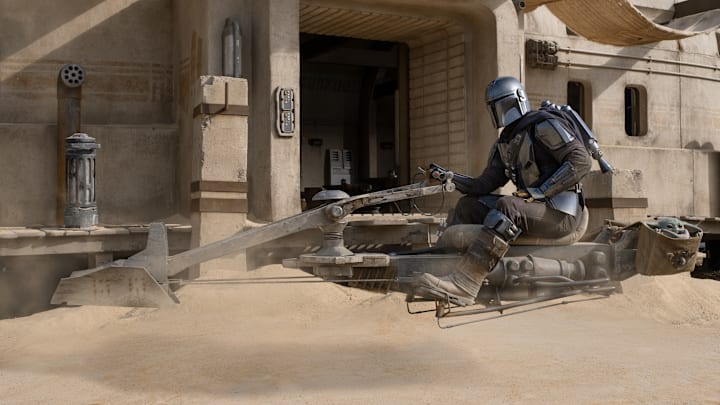 The Mandalorian (Pedro Pascal) and the Child in THE MANDALORIAN, season two, exclusively on Disney+