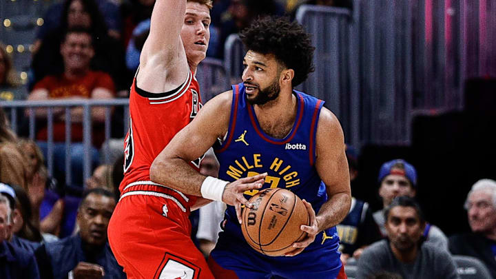 Mar 24, 2025; Denver, Colorado, USA; Denver Nuggets guard Jamal Murray (27) controls the ball as Chicago Bulls guard Kevin Huerter (13) guards in the first quarter at Ball Arena. Mandatory Credit: Isaiah J. Downing-Imagn Images