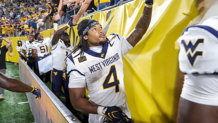 Sep 19, 2026; Charlotte, North Carolina, USA; West Virginia Mountaineers running back Cam Cook (4) celebrates with fans after defeating the Virginia Cavaliers at Bank of America Stadium. Mandatory Credit: Ben Queen-Imagn Images Sep 19, 2026; Charlotte, North Carolina, USA; West Virginia Mountaineers running back Cam Cook (4) celebrates with fans after defeating the Virginia Cavaliers at Bank of America Stadium. Mandatory Credit: Ben Queen-Imagn Images