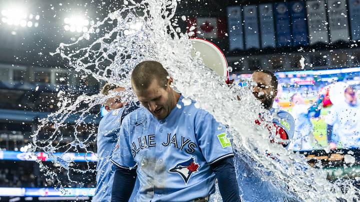 May 13, 2026; Toronto, Ontario, CAN; Toronto Blue Jays center fielder Daulton Varsho (5) gets splashed with water after hitting a grand slam walk off to defeat the Tampa Bay Rays during the tenth inning at Rogers Centre. Mandatory Credit: Kevin Sousa-Imagn Images