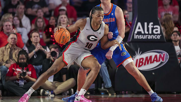Feb 25, 2025; Athens, Georgia, USA; Georgia Bulldogs forward RJ Godfrey (10) dribbles against Florida Gators center Micah Handlogten (3) during the second half at Stegeman Coliseum. Mandatory Credit: Dale Zanine-Imagn Images