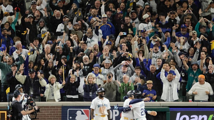 Oct 17, 2025; Seattle, Washington, USA; Fans react as Seattle Mariners third baseman Eugenio Suarez (28) celebrates after hitting a grand slam against the Toronto Blue Jays in the eighth inning during game five of the ALCS round for the 2025 MLB playoffs at T-Mobile Park. Mandatory Credit: John Froschauer-Imagn Images Oct 17, 2025; Seattle, Washington, USA; Fans react as Seattle Mariners third baseman Eugenio Suarez (28) celebrates after hitting a grand slam against the Toronto Blue Jays in the eighth inning during game five of the ALCS round for the 2025 MLB playoffs at T-Mobile Park. Mandatory Credit: John Froschauer-Imagn Images