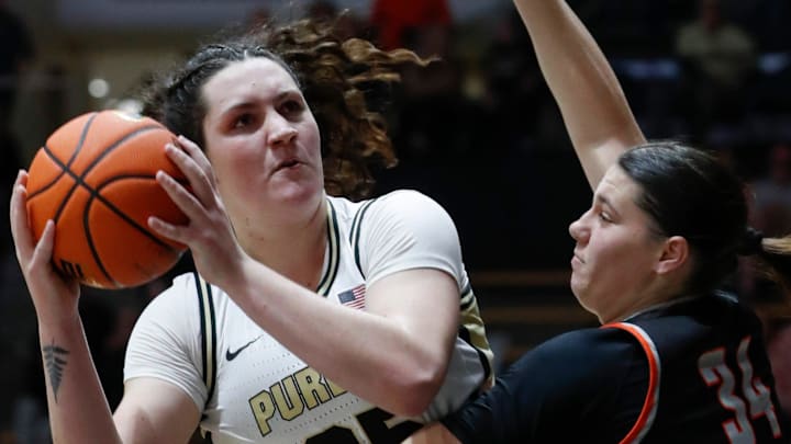 Purdue Boilermakers forward Lana McCarthy (35) is defended by Indiana Tech Warriors center Lauren Barton (34). Purdue Boilermakers forward Lana McCarthy (35) is defended by Indiana Tech Warriors center Lauren Barton (34).