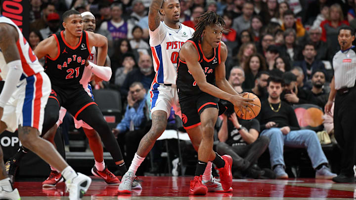 Apr 4, 2025; Toronto, Ontario, CAN;  Toronto Raptors guard Ja'Kobe Walter (14) controls the ball in front of Detroit Pistons forward Ron Halland II (00) in the first half at Scotiabank Arena. Mandatory Credit: Dan Hamilton-Imagn Images