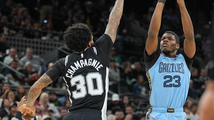 Nov 18, 2025; San Antonio, Texas, USA;  Memphis Grizzlies forward Cedric Coward (23) shoots in front of San Antonio Spurs forward Julian Champagnie (30) in the second half at Frost Bank Center. Mandatory Credit: Daniel Dunn-Imagn Images