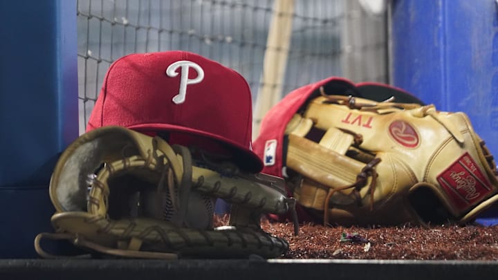 Aug 16, 2023; Toronto, Ontario, CAN; A Philadelphia Phillies cap and glove sit in the dugout during a game against the Toronto Blue Jays at Rogers Centre. Mandatory Credit: John E. Sokolowski-Imagn Images