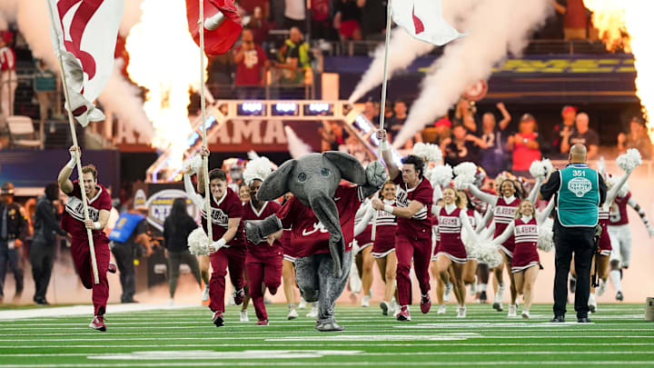 Big Al and the Alabama cheerleaders lead the Crimson Tide onto the field before the 2021 College Football Playoff Semifinal game at the 86th Cotton Bowl in AT&T Stadium in Arlington, Texas Friday, Dec. 31, 2021. Alabama defeated Cincinnati 27-6 to advance to the national championship game. 