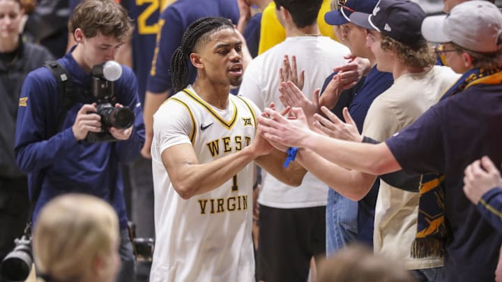 Mar 6, 2026; Morgantown, West Virginia, USA; West Virginia Mountaineers guard Jasper Floyd (1) celebrates with fans after defeating the UCF Knights at Hope Coliseum. Mandatory Credit: Ben Queen-Imagn Images