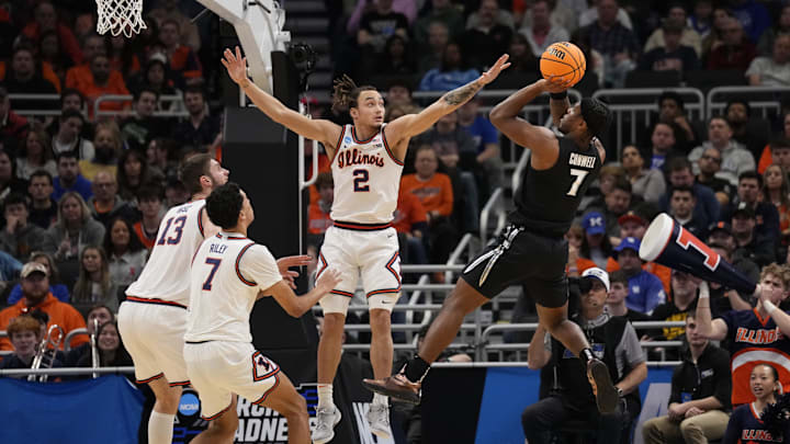 Mar 21, 2025; Milwaukee, WI, USA: Xavier Musketeers guard Ryan Conwell (7) shoots a layup past Illinois Fighting Illini guard Dra Gibbs-Lawhorn (2) during the first half at Fiserv Forum. Mandatory Credit: Jeff Hanisch-Imagn Images