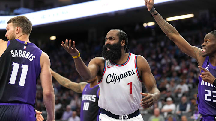 Apr 11, 2025; Sacramento, California, USA; Los Angeles Clippers guard James Harden (1) and Sacramento Kings guard Keon Ellis (23) react after no foul was called during the third quarter at Golden 1 Center. Mandatory Credit: Darren Yamashita-Imagn Images