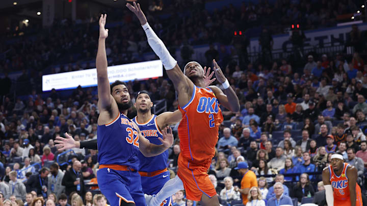 Jan 3, 2025; Oklahoma City, Oklahoma, USA; Oklahoma City Thunder guard Shai Gilgeous-Alexander (2) goes up for a basket in front of New York Knicks center Karl-Anthony Towns (32) during the second half at Paycom Center. Mandatory Credit: Alonzo Adams-Imagn Images