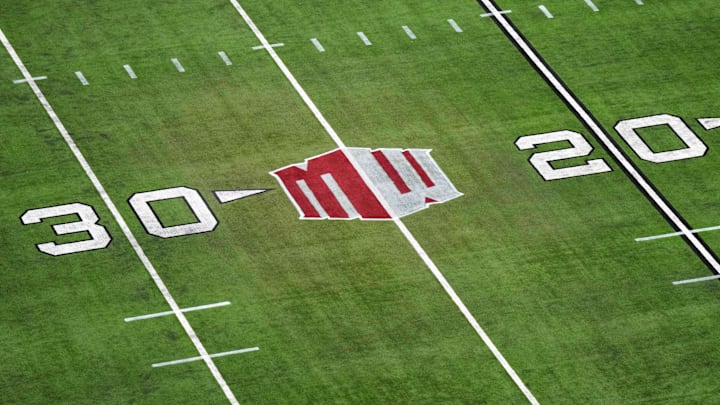 The Mountain West conference logo on the field at Allegiant Stadium. Mandatory Credit: Kirby Lee-Imagn Images