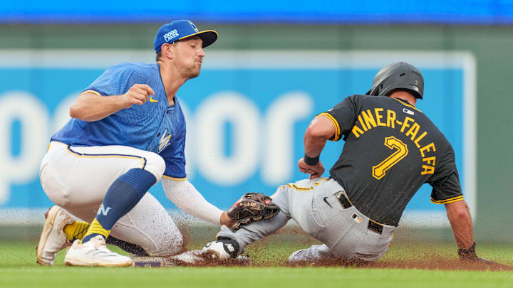 Jul 11, 2025; Minneapolis, Minnesota, USA; Minnesota Twins second base Brooks Lee (2) catches a throw from catcher Christian Vázquez (8) but not in time to catch the stealing Pittsburgh Pirates shortstop Isiah Kiner-Falefa (7) in the second inning at Target Field. Mandatory Credit: Matt Blewett-Imagn Images
